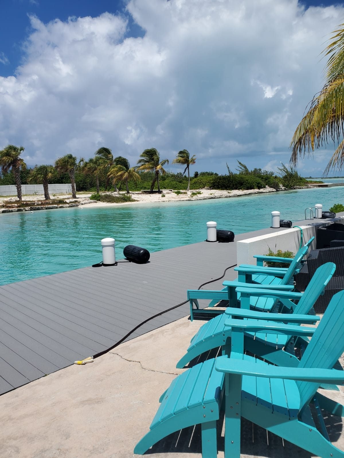 Loungers beside the dock looking across the channel