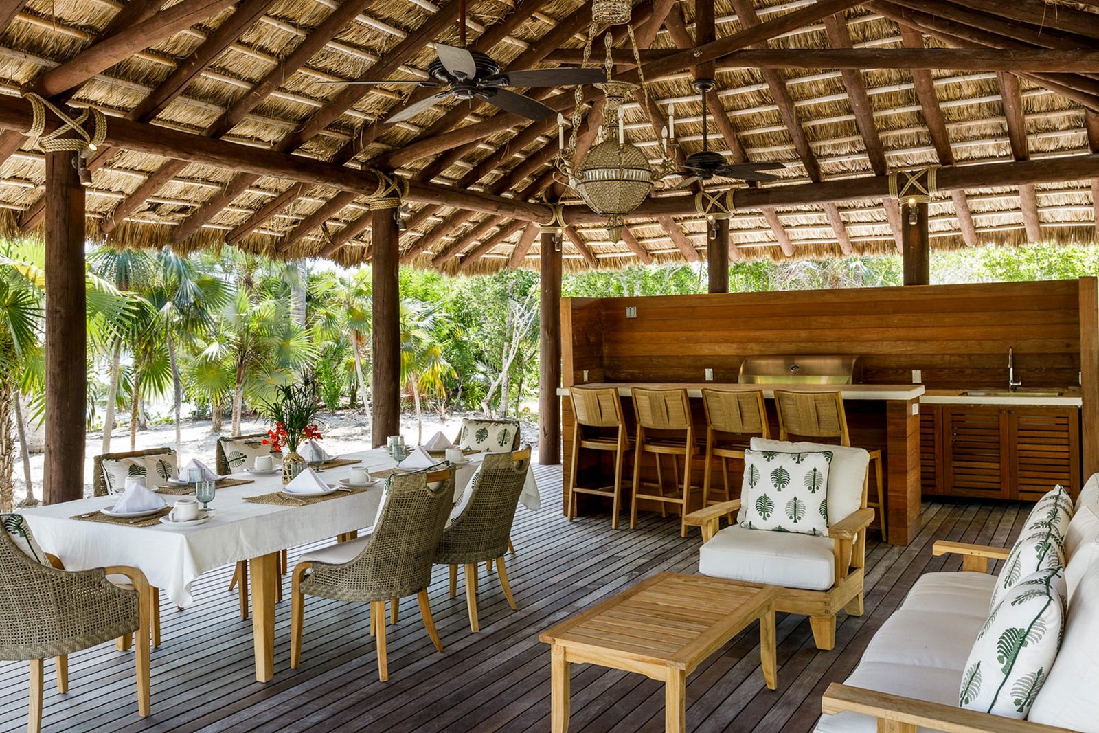 The thatched dining pavilion and bar beside the pool