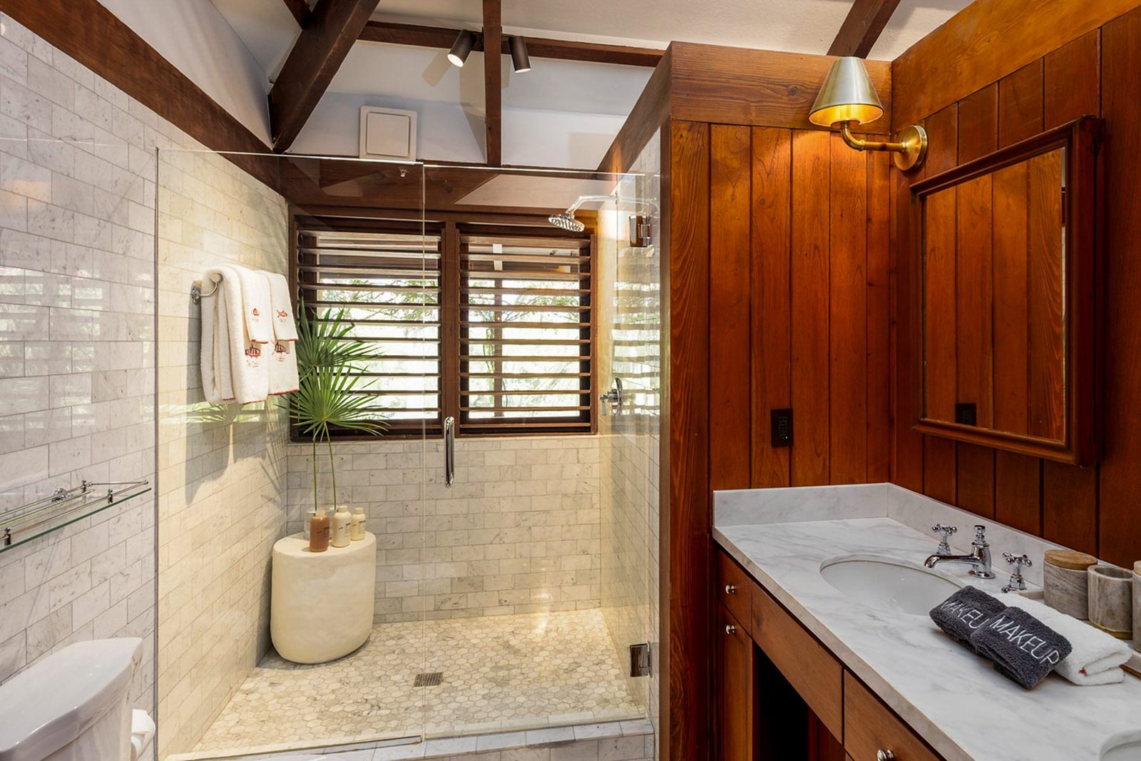 An ensuite bathroom in marble and timber