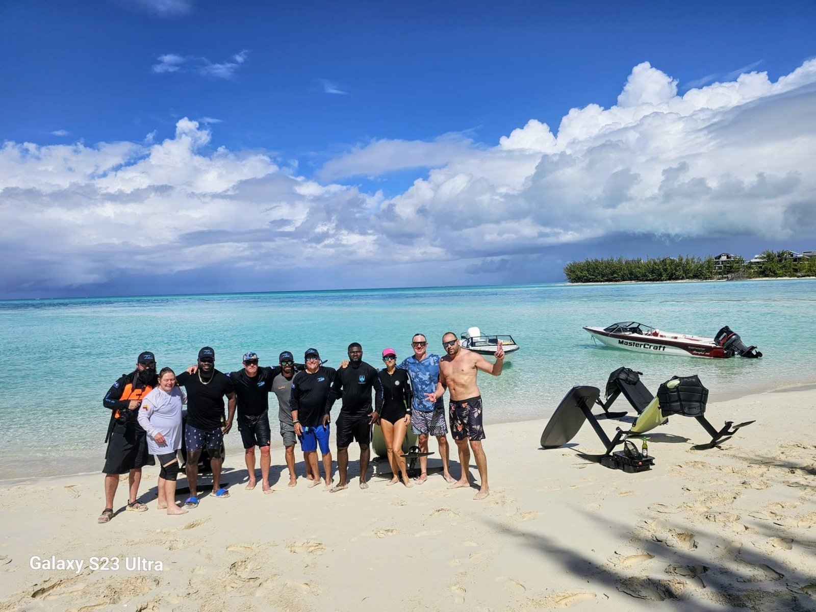 The T.F.X. I group on the beach with the boats and boards